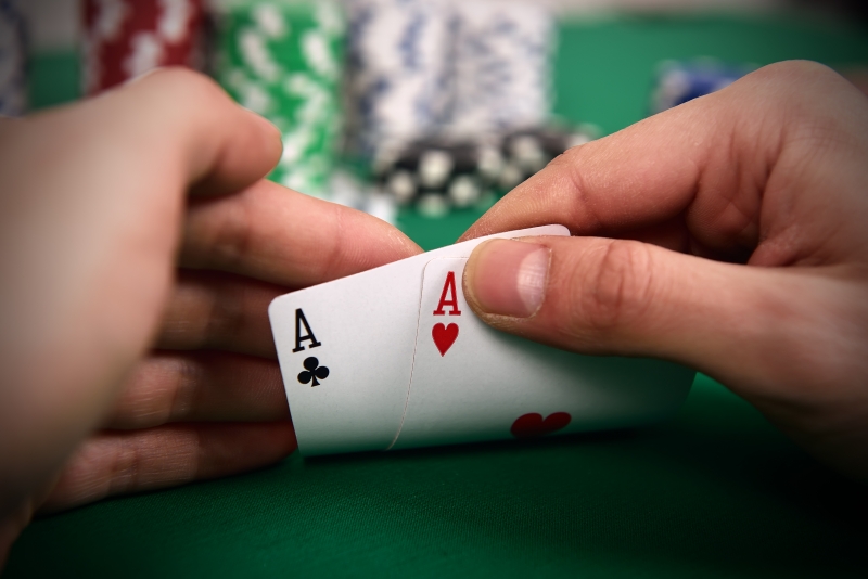 11919677-poker-player-with-two-aces